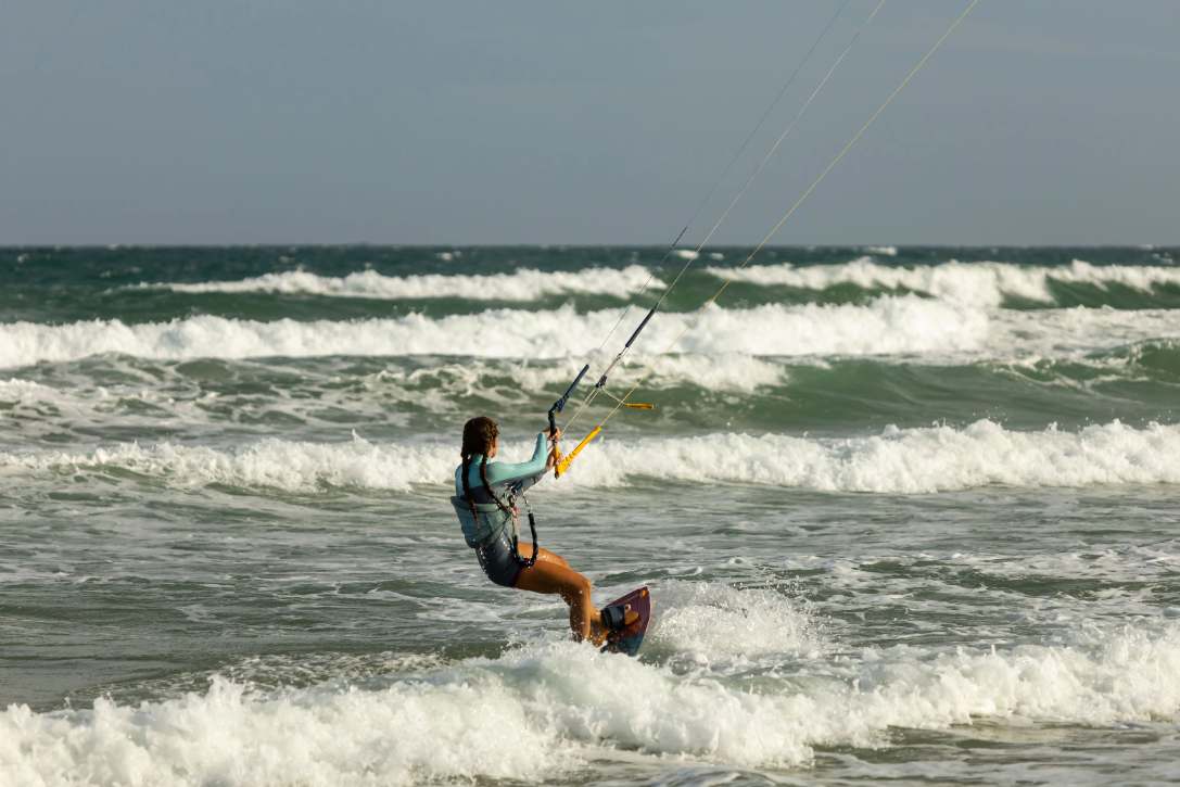 Kitesurfer surfing along the Paje waves in Zanzibar during the 2026 season.